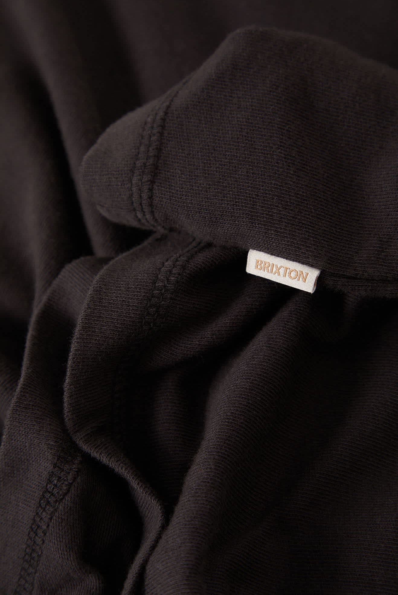 Women's Carefree Organic Garment Dye Cropped Henley in the color Black - Additional Laydown image