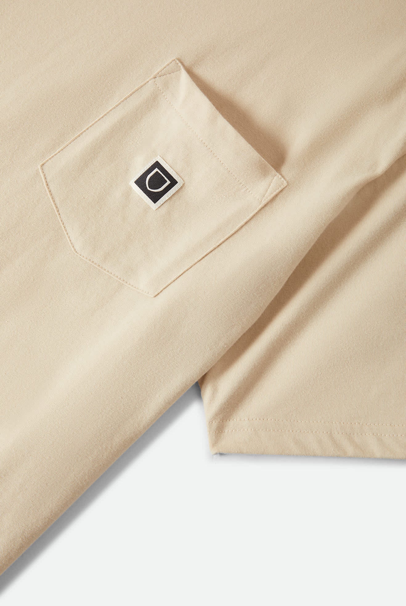 Men's Beta Sheild Short Sleeve Pocket T-Shirt in the color Cream - Additional Laydown image