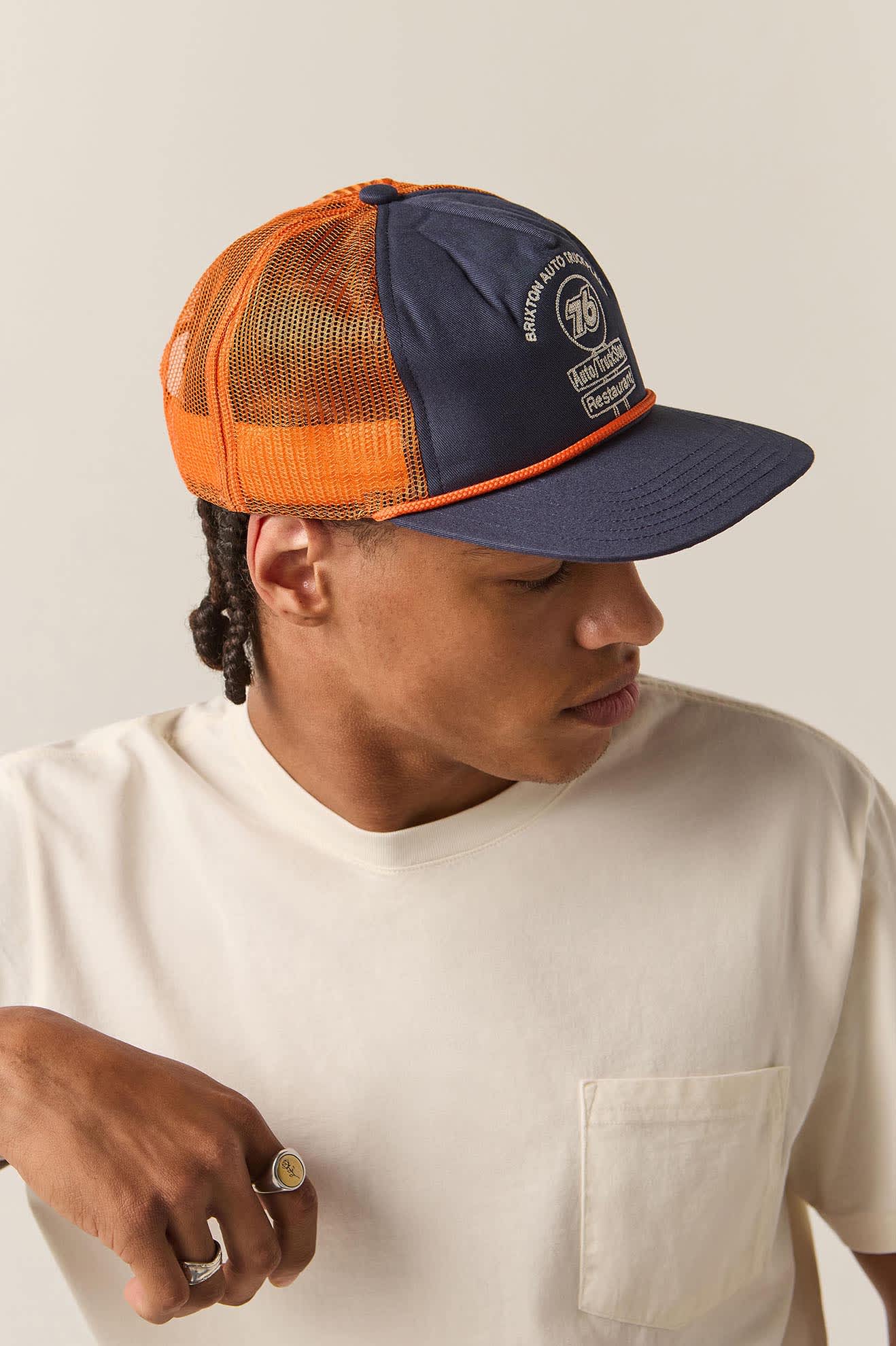 Unisex 76 Truck Stop Trucker Hat in the color Navy/Orange - Men's Side View