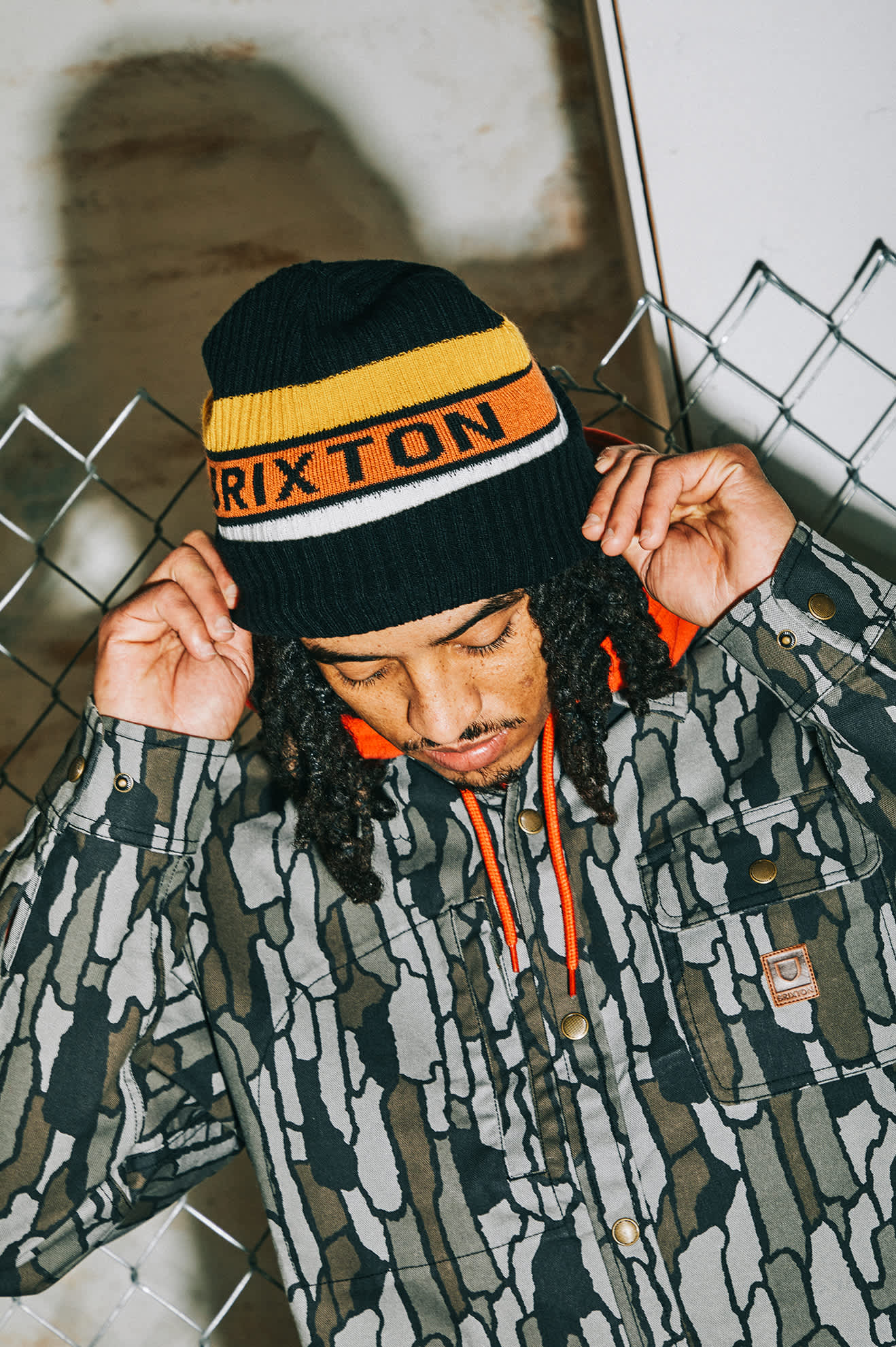 Men's Rainier Striped Beanie in the color Black/Yellow/Orange - Men's Lifestyle image